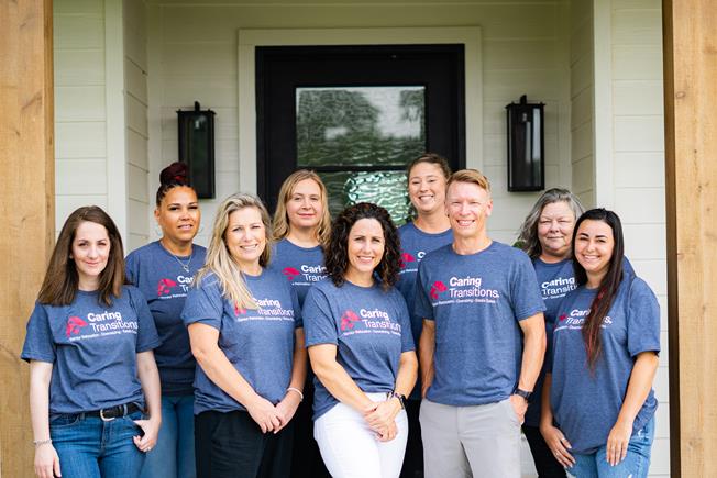 Caring Transitions of Brazos Valley staff standing in front of a home.